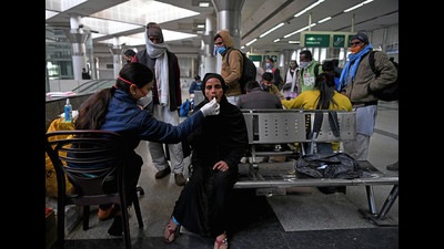 A health care worker takes a swab sample of a passenger for the COVID-19 test, at Kashmere Gate ISBT, in view of rising Omicron cases, in New Delhi on Monday. (Rahul Singh) A health care worker takes a swab sample of a passenger for the COVID-19 test, at Kashmere Gate ISBT, in view of rising Omicron cases, in New Delhi on Monday. (Rahul Singh)