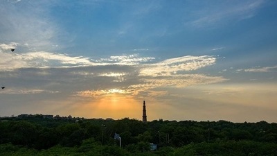 &nbsp;A cloudy sky and a view of the Qutub Minar, at Mehrauli in New Delhi.