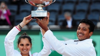 Sania Mirza and Mahesh Bhupathi of India pose with the winners trophy after defeating Klaudia Jans-Ignacik of Poland and Santiago Gonzalez of Mexico in the mixed doubles final of French Open. (Getty Images)
