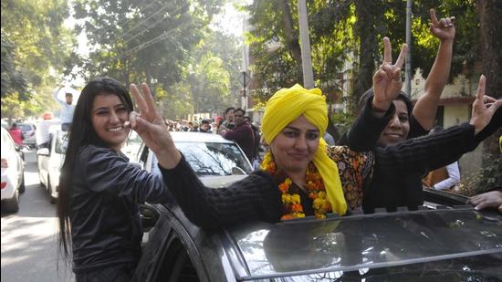 Aam Aadmi Party supporters celebrate after winning Municipal Corporation poll at Sector 20 in Chandigarh on Monday. (Keshav Singh/ HT photo)