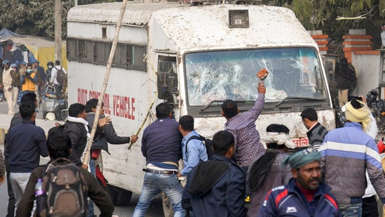 Visuals of the violence that went viral on social media showed a large group of people surrounding the police vehicles, climbing on top of them, pelting them with stones and then thrashing them with sticks, leaving the vehicles in shambles.(PTI) Visuals of the violence that went viral on social media showed a large group of people surrounding the police vehicles, climbing on top of them, pelting them with stones and then thrashing them with sticks, leaving the vehicles in shambles.(PTI)