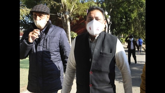 Outgoing mayor Ravi Kant Sharma (right) leaves the polling booth at Sector 20 in Chandigarh on Monday. A strong anti-incumbency factor played a key role in the BJP’s defeat in the Chandigarh MC poll. It was reduced to the second position after AAP. (Keshav Singh/ HT)