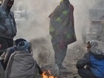 People warm themselves around a bonfire on a cold winter morning at Ghazipur market in New Delhi. (Raj K Raj / HT Photo) People warm themselves around a bonfire on a cold winter morning at Ghazipur market in New Delhi. (Raj K Raj / HT Photo)