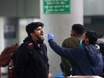 A healthcare worker collects a swab sample of a passenger at Kashmere Gate ISBT amid a surge in Omicron cases, in Delhi on Tuesday. (ANI) A healthcare worker collects a swab sample of a passenger at Kashmere Gate ISBT amid a surge in Omicron cases, in Delhi on Tuesday. (ANI)