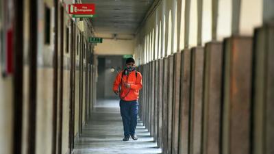 A worker sanitising the premises of a school in Delhi. (HT Archive) A worker sanitising the premises of a school in Delhi. (HT Archive)