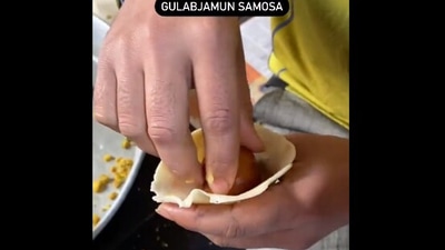 The image shows an individual putting a gulab jamum as a samosa filling. (Twitter/@Mirage_gurrl)
