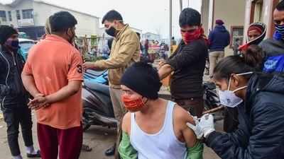 A man receives a dose of the Covid-19 vaccine at a market in New Delhi on Tuesday. The restrictions have been imposed in the national capital due to rising number of Covid cases. (PTI Photo) A man receives a dose of the Covid-19 vaccine at a market in New Delhi on Tuesday. The restrictions have been imposed in the national capital due to rising number of Covid cases. (PTI Photo)