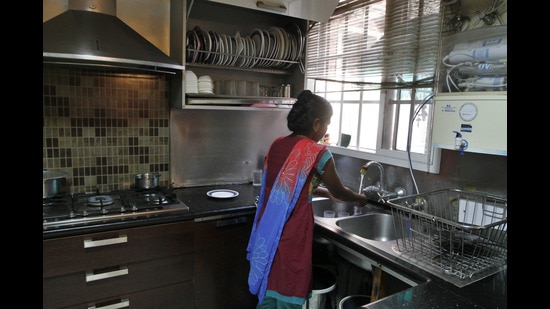 A domestic worker in the kitchen of an apartment in Gurgaon. (Sanjeev Verma/Hindustan Times)