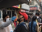 A health worker collects a swab sample for Covid-19 test, at Patel Nagar, on Tuesday. (Sanchit Khanna/HT)