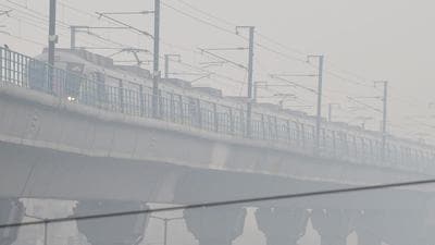 A metro train runs amid low visibility due to fog on a cold morning in New Delhi recently. (PTI)