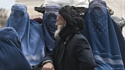 An Afghan man along with Burqa clad Afghan women ride on a vehicle along a road in Mazar-i-Sharif. (AFP) An Afghan man along with Burqa clad Afghan women ride on a vehicle along a road in Mazar-i-Sharif. (AFP)