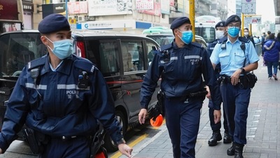 Police officers guard outside the building of Stand News' office in Hong Kong, Hong Kong police say they have arrested several current and former staff members of the online media company for conspiracy to publish a seditious publication. (AP Photo/Vincent Yu) (AP)