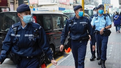 Police officers guard outside the building of Stand News' office in Hong Kong, Hong Kong police say they have arrested several current and former staff members of the online media company for conspiracy to publish a seditious publication.&nbsp; (AP)