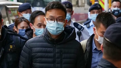 Stand News chief editor Patrick Lam is brought to the news outlet's office building in handcuffs after police were deployed to search the premises in Hong Kong's Kwun Tong district. (AFP Photo) Stand News chief editor Patrick Lam is brought to the news outlet's office building in handcuffs after police were deployed to search the premises in Hong Kong's Kwun Tong district. (AFP Photo)