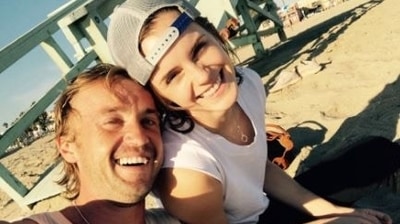 Tom Felton and Emma Watson pose together.
