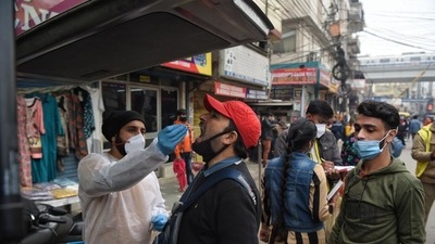 A health worker collects a swab sample for Covid-19 test, at Patel Nagar, on Tuesday. (Sanchit Khanna/HT)