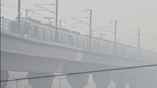 A metro train runs amid low visibility due to fog on a cold morning in New Delhi recently. (PTI)