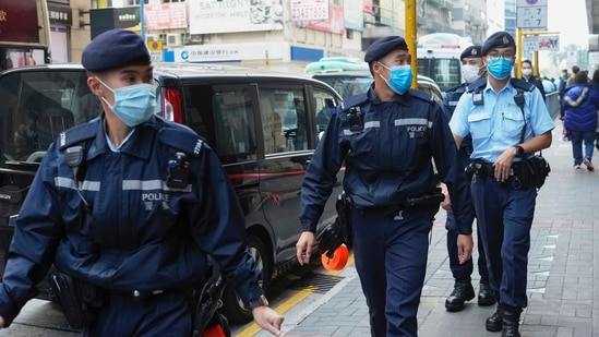 Police officers guard outside the building of Stand News' office in Hong Kong, Hong Kong police say they have arrested several current and former staff members of the online media company for conspiracy to publish a seditious publication. (AP Photo/Vincent Yu)(AP)