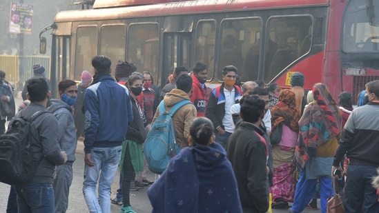 Passengers wait to board buses as DTC buses are operating at 50% starting from Wednesday.(PTI)