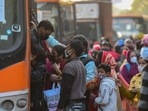 People rush to board a DTC bus after Delhi government’s decision to run DTC buses with 50% capacity in the wake of rising Covid-19 cases in New Delhi. (Amal KS/HT Photo)