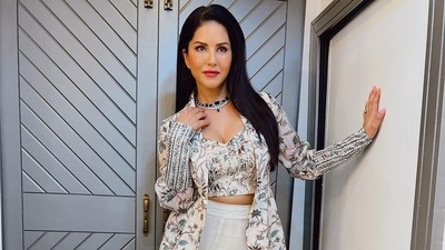 Taking to her social media handle, Sunny shared a slew of pictures featuring her donning a white base crop top that sported earthy tone floral prints all over and came with a deep V-neck to raise the hotness quotient. &nbsp; (Instagram/sunnyleone)