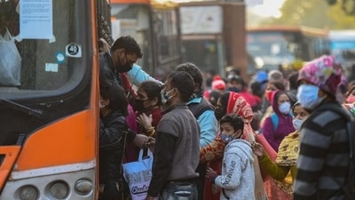 People rush to board a DTC bus after Delhi government’s decision to run DTC buses with 50% capacity in the wake of rising Covid-19 cases in New Delhi. (Amal KS/HT Photo)