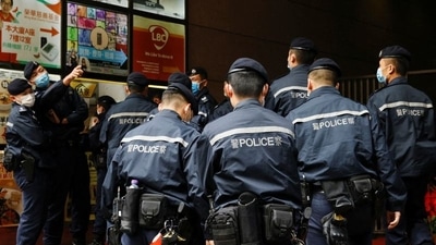 Police are seen outside the Stand News office building, after a raid in which seven people were arrested, on Wednesday. (Reuters Photo)