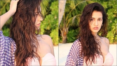 Leaving her wet luscious tresses open down and swept across one shoulder, Disha accessorised the look with a pair of golden hoop earrings and a cross pendant. &nbsp; (Instagram/dishapatani)