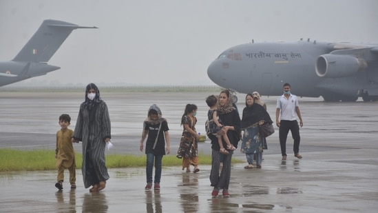 Passengers disembark from Indian Air Force's C17 Globemaster at Hindon Air Force Station after being evacuated from Kabul, in Ghaziabad, on August 21. India along with many other countries evacuated scores of Afghans amid the the Taliban takeover crisis.(Sakib Ali / HT Photo)