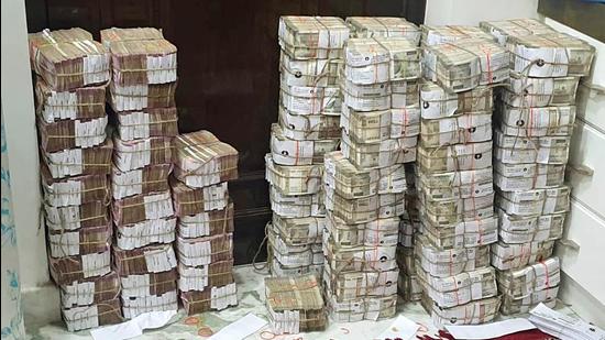 Cash and sandalwood recovered from businessIman Piyush Jain's residence during a raid conduct by the team of GST Intelligence, in Kannauj on Monday. (Arshad Khan)