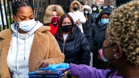 People line up to receive test kits to detect Covid-19 in New York.(AP Photo)