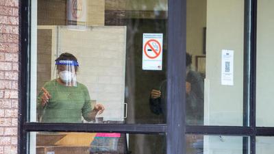 An employee screens a person entering Eatonville Care Centre after new provincial rules limiting visitations at long term care homes come into effect due to spiking coronavirus disease (Covid-19) case numbers in Toronto, Ontario, Canada. (REUTERS) An employee screens a person entering Eatonville Care Centre after new provincial rules limiting visitations at long term care homes come into effect due to spiking coronavirus disease (Covid-19) case numbers in Toronto, Ontario, Canada. (REUTERS)
