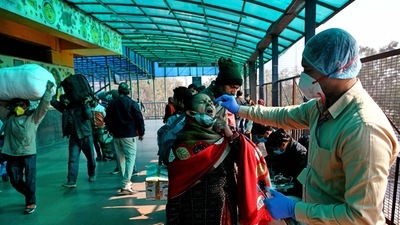 A healthcare worker collects a swab sample of a passenger for the Covid-19 testing at New Delhi Railway Station. A healthcare worker collects a swab sample of a passenger for the Covid-19 testing at New Delhi Railway Station. 