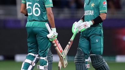 Dubai : Pakistan's captain Babar Azam, left, and Mohammad Rizwan speak between overs during the Cricket Twenty20 World Cup semi-final match between Pakistan and Australia in Dubai, UAE, Thursday, Nov. 11, 2021. AP/PTI(AP11_11_2021_000203A) (AP) Dubai : Pakistan's captain Babar Azam, left, and Mohammad Rizwan speak between overs during the Cricket Twenty20 World Cup semi-final match between Pakistan and Australia in Dubai, UAE, Thursday, Nov. 11, 2021. AP/PTI(AP11_11_2021_000203A) (AP)