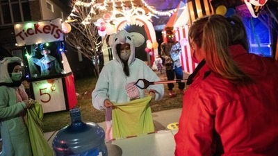A resident gives out Halloween treats using a reacher-grabber tool as a measure against Covid-19, as part of a fundraiser for the food bank at a decorated home in Ottawa Ontario, Saturday, October 31, 2020. (AP Photo/Justin Tang) A resident gives out Halloween treats using a reacher-grabber tool as a measure against Covid-19, as part of a fundraiser for the food bank at a decorated home in Ottawa Ontario, Saturday, October 31, 2020. (AP Photo/Justin Tang)