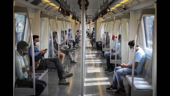 Many commuters are resorting to carpooling or additional travel time to sail through the curbs as part of the yellow alert restrictions, which allow only 50% capacity in Delhi Metro. (Photo: Sanchit Khanna/HT)