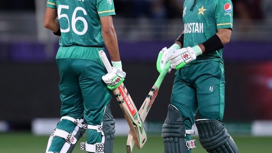Dubai : Pakistan's captain Babar Azam, left, and Mohammad Rizwan speak between overs during the Cricket Twenty20 World Cup semi-final match between Pakistan and Australia in Dubai, UAE, Thursday, Nov. 11, 2021. AP/PTI(AP11_11_2021_000203A)(AP)