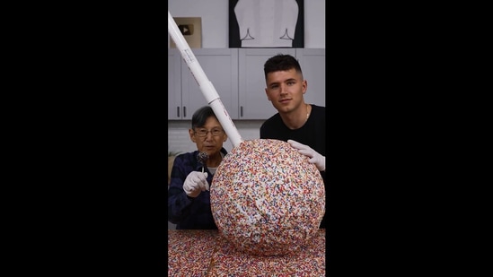 The image shows the team members comparing their giant cake pop with a regular one.(Instagram/@nick.digiovanni and cookingwithlynja)