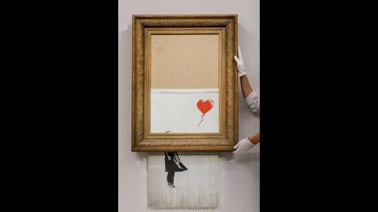 Banksy’s work titled Love Is In The Bin, sold for a record price at an auction in 2021. (Photo: Sotheby’s)