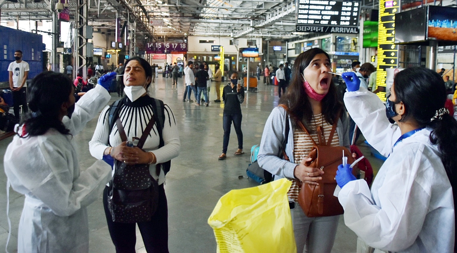 Healthcare workers collect nasal samples of passengers arriving from other states for the Covid-19 testing in Mumbai. (ANI Photo) Healthcare workers collect nasal samples of passengers arriving from other states for the Covid-19 testing in Mumbai. (ANI Photo)