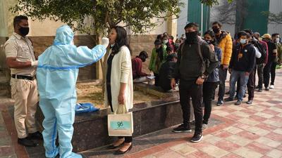 New Delhi, India - January 01, 2022: A health worker collects swab samples for Covid-19 test, at Sarojini Nagar Market, in New Delhi, India, on Saturday, January 01, 2022. (Photo by Sanchit Khanna/ Hindustan Times) New Delhi, India - January 01, 2022: A health worker collects swab samples for Covid-19 test, at Sarojini Nagar Market, in New Delhi, India, on Saturday, January 01, 2022. (Photo by Sanchit Khanna/ Hindustan Times)