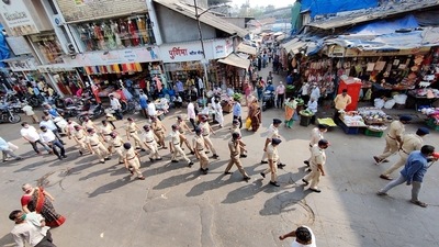 A flag march is being conducted by the Thane Police, asking people to follow Covid-19 guidelines issued by Maharashtra government, in Thane on Friday. (ANI Photo)