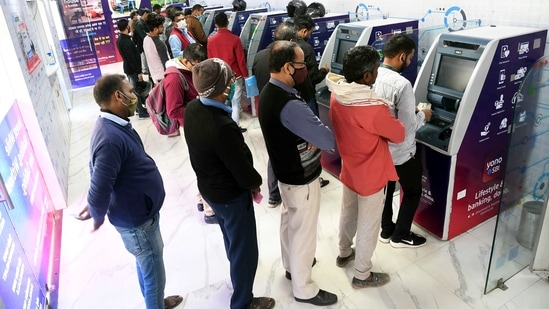 People wait in queues to withdraw cash from ATMs(ANI)