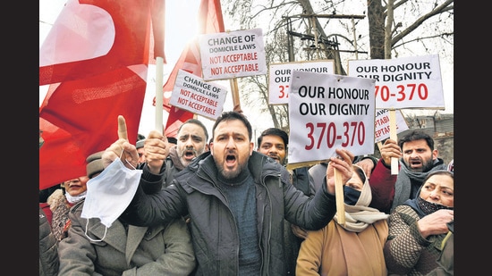 Srinagar, India - January 01, 2022: Activists of National Conference shout slogans and hold placards during a protest against the delimitation commission in Srinagar, Jammu and Kashmir, India on Saturday, January 1, 2022. People's Alliance for Gupkar Declaration (PAGD), an amalgam of Jammu and Kashmir's regional parties, had announced a sit in protest against recommendations of the commission. PAGD spokesperson said its leaders have been placed under house arrest ahead of today's protest. (Photo by Waseem Andrabi/Hindustan Times) Srinagar, India - January 01, 2022: Activists of National Conference shout slogans and hold placards during a protest against the delimitation commission in Srinagar, Jammu and Kashmir, India on Saturday, January 1, 2022. People's Alliance for Gupkar Declaration (PAGD), an amalgam of Jammu and Kashmir's regional parties, had announced a sit in protest against recommendations of the commission. PAGD spokesperson said its leaders have been placed under house arrest ahead of today's protest. (Photo by Waseem Andrabi/Hindustan Times)