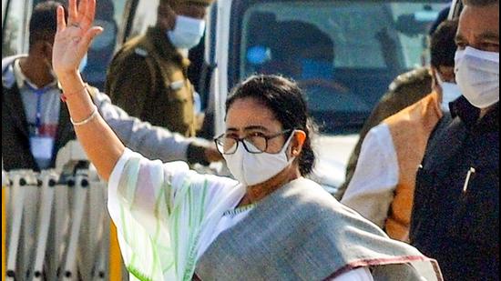 West Bengal Chief Minister Mamata Banerjee waves at her supporters as she departs for Kolkata after her three-day visit to Gangasagar, in South 24 Parganas district. (PTI PHOTO.)