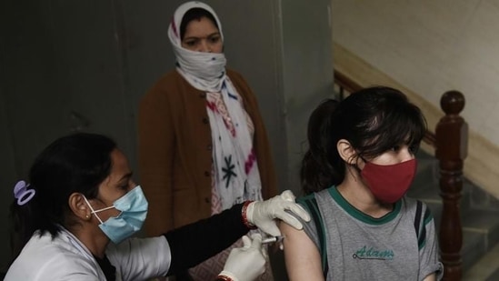 A woman gets a dose of Covid-19 vaccine at an urban primary health centre in Gurugram’s Sector 31. (Vipin Kumar/HT PHOTO)