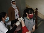 A woman gets a dose of the Covid-19 vaccine at an urban primary health center in Gurugram’s Sector 31 on Tuesday.&nbsp;