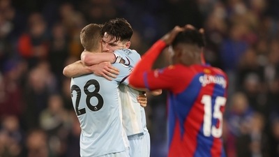 Crystal Palace's Jeffrey Schlupp, right, reacts as West Ham's captain Declan Rice, center, hugs teammate Tomas Soucek to celebrate their win in the English Premier League soccer match between Crystal Palace and West Ham United at Selhurst Park stadium in London, England, Saturday, Jan. 1, 2022. West Ham United won 3-2. (AP)