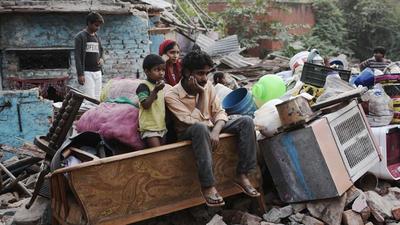 A man near his demolished shanty as the DDA conducted a demolition drive at Katputli Colony in 2016. (HT archive)