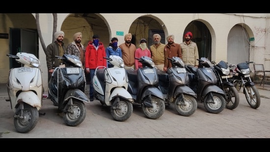 The accused with the stolen vehicles in Ludhiana on Sunday. (HT Photo)